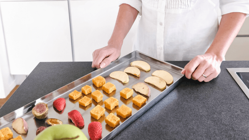 freeze dried fruit on a kichen counter next to fresh fruit